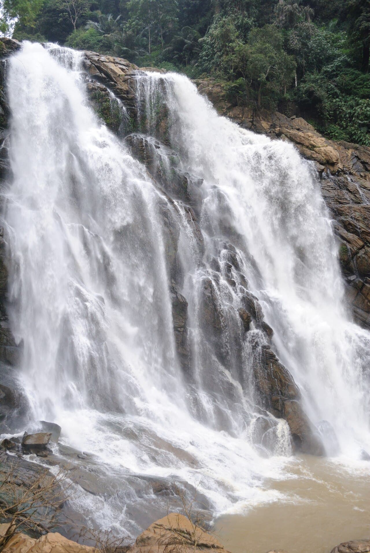 White water flowing down the rocky tiers of Meenmutty Falls in Wayanad