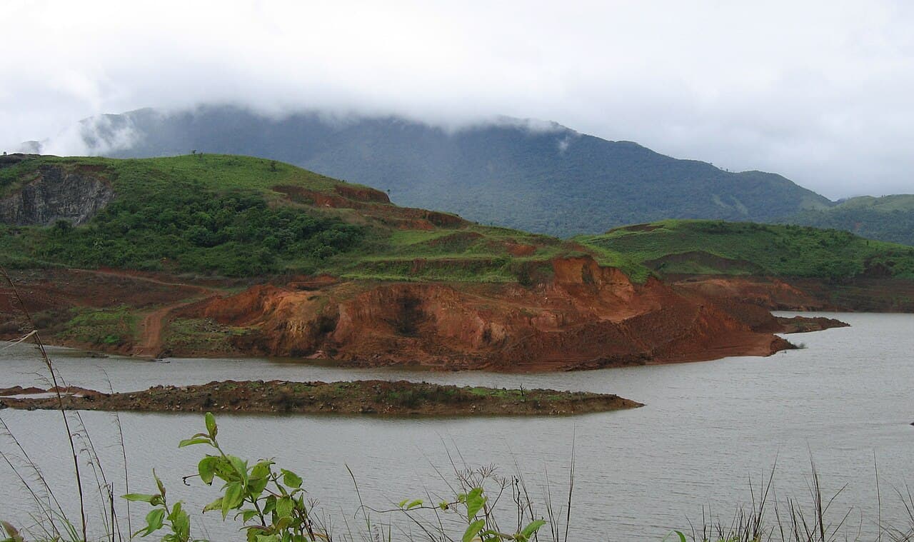 Banasura Sagar reservoir beneath green, cloud-covered hills