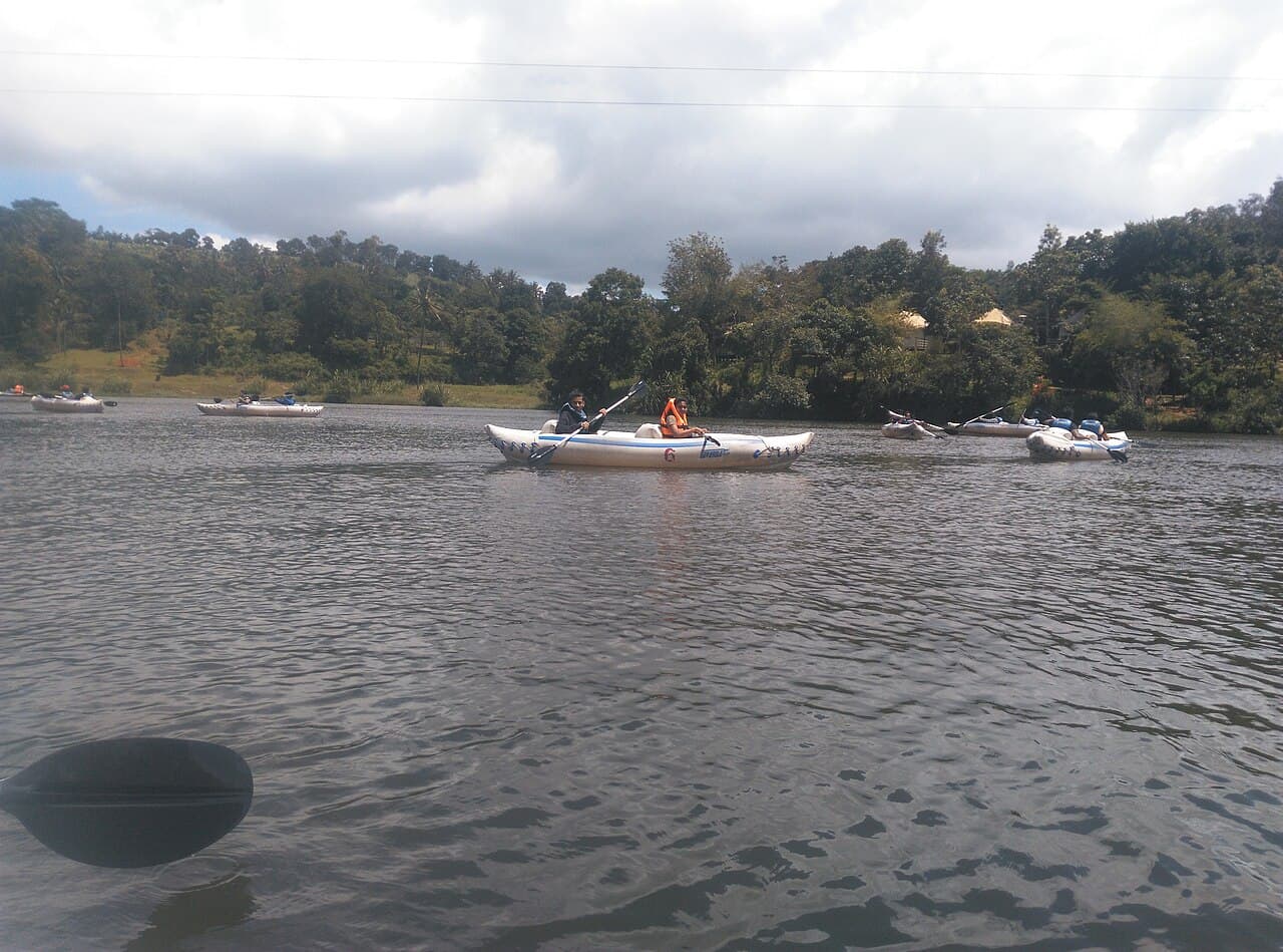 Visitors kayaking across Karlad Lake in Wayanad