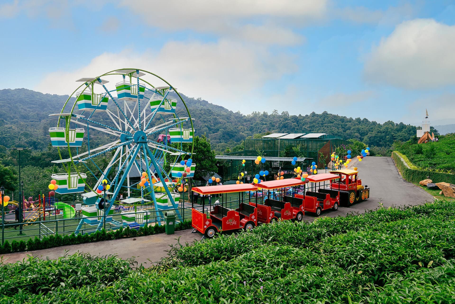 Ferris wheel, miniature train and children's rides at Komachi Park in Wayanad